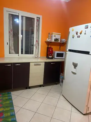 a kitchen with a white refrigerator and a window at La casa di Frank, con piscina privata in Campofelice di Roccella