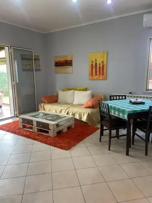 a living room with a couch and a table at La casa di Frank, con piscina privata in Campofelice di Roccella
