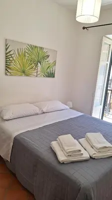 a bedroom with a bed with two towels on it at San Marco Rooms in Palermo