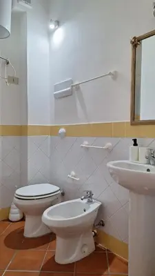 a bathroom with a toilet and a sink at San Marco Rooms in Palermo