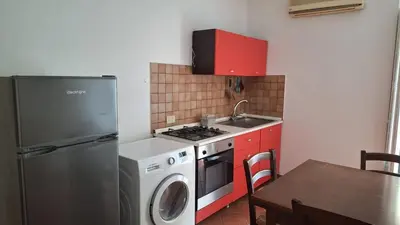a kitchen with a refrigerator and a washing machine at San Marco Rooms in Palermo