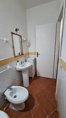 a bathroom with a toilet and a sink at San Marco Rooms in Palermo