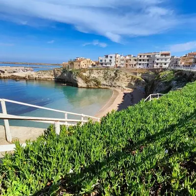 a view of a beach with buildings on a cliff at La Finestra Sul Tirreno in Terrasini