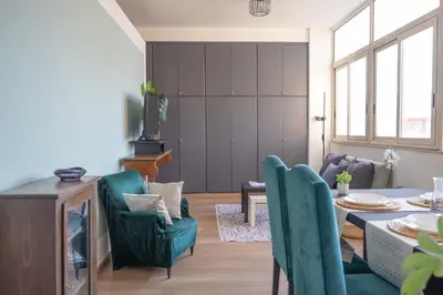a living room with a table and chairs at Taléa - Design Apartment a Palermo in Palermo