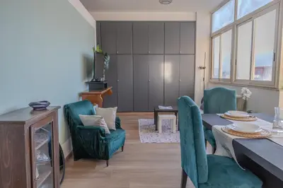 a living room with a dining room table and chairs at Taléa - Design Apartment a Palermo in Palermo