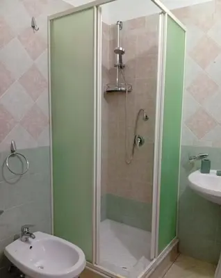 a bathroom with a shower and a toilet and a sink at Sicilia Bedda Casa Vacanze in Lascari