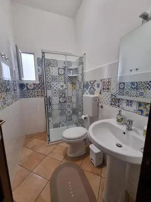 a bathroom with a toilet and a sink and a shower at A casa dei nonni in Terrasini