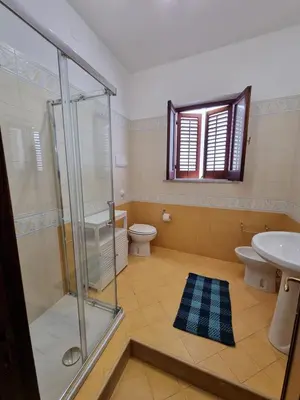 a bathroom with a shower and a toilet and a sink at A casa dei nonni in Terrasini