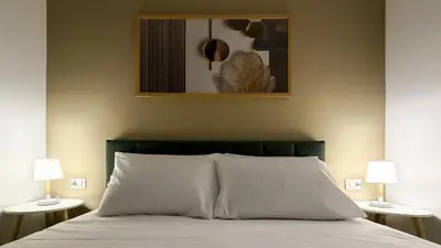 a bedroom with a bed with two lamps on both sides at Street316 in Cinisi