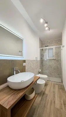 a bathroom with a sink and a tub and a toilet at Street316 in Cinisi