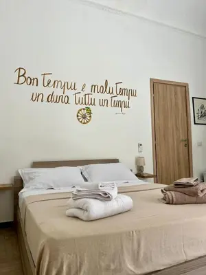 a bedroom with a bed with towels on it at Camera Verga in Palermo