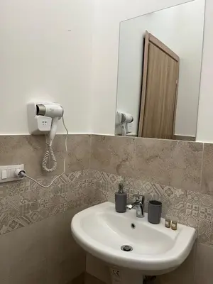 a bathroom with a sink and a mirror at Camera Verga in Palermo