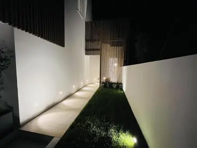 a hallway with white walls and a green grass at Design Villa with private pool in Carini