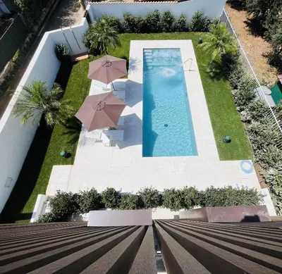 an overhead view of a swimming pool with umbrellas at Design Villa with private pool in Carini