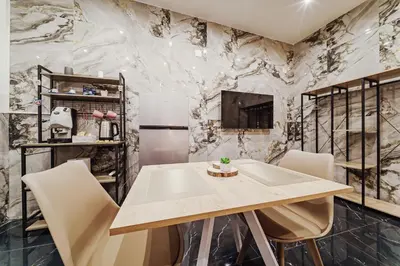 a dining room with a table and chairs at Kamel home in Palermo