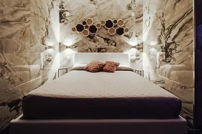 a bedroom with a bed with two pillows on it at Kamel home in Palermo