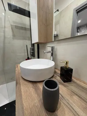 a bathroom with a large white tub on a wooden counter at Kamel home in Palermo