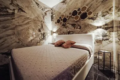 a bedroom with a bed with two pillows on it at Kamel home in Palermo