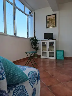 a living room with a couch and a tv at Villa sul mare in Isola delle Femmine