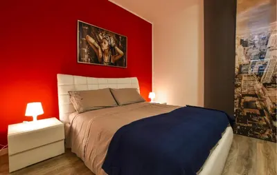 a bedroom with a red wall and a bed at Amazing Home In Monreale in Monreale