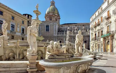 a fountain with statues in front of a building at Amazing Home In Monreale in Monreale