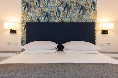 a bedroom with a large bed with two pillows at URBAN Palermo DOWNTOWN in Palermo