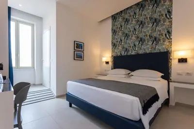 a bedroom with a large bed with a large headboard at URBAN Palermo DOWNTOWN in Palermo