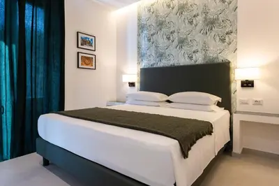 a bedroom with a large white bed in a room at URBAN Palermo DOWNTOWN in Palermo