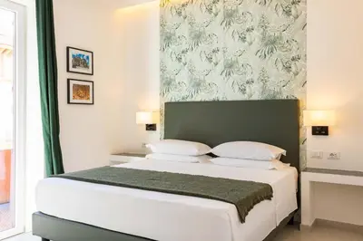 a bedroom with a white bed with a green headboard at URBAN Palermo DOWNTOWN in Palermo