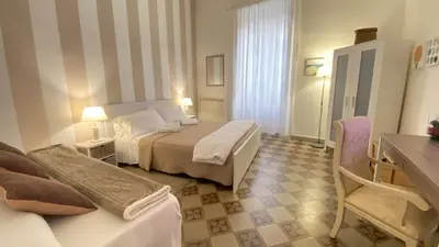 a hotel room with a bed and a couch at BB Essenze Club in Palermo