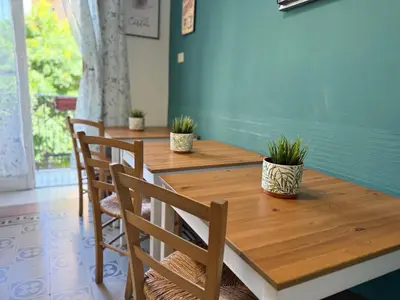a wooden table with chairs and potted plants on it at BB Essenze Club in Palermo