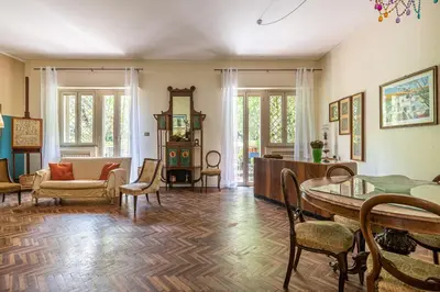 a living room with a table and chairs at Un Giardino Segreto a Palermo by Wonderful Italy in Palermo