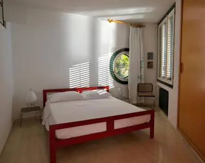 a bedroom with a red and white bed and a window at Modernist Villa With Private Sea Access in Bagheria