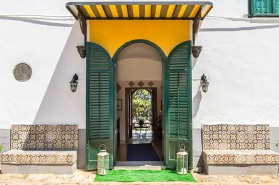 an entrance to a building with a green and yellow door at Baglio del Grillo in Grisi