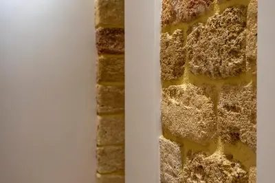 a brick wall next to a white wall at Isidoro Luxury Suites in Palermo