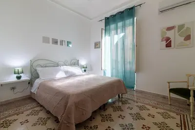 a bedroom with a bed and a large window at GuestHouse - 21 Steps to Everywhere in Palermo in Palermo