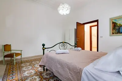 a bedroom with a bed with two towels on it at GuestHouse - 21 Steps to Everywhere in Palermo in Palermo