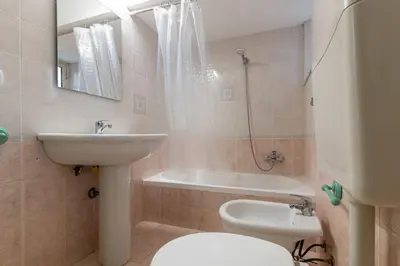 a bathroom with a sink and a toilet and a bath tub at GuestHouse - 21 Steps to Everywhere in Palermo in Palermo