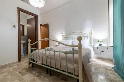 a bedroom with a white bed and a mirror at GuestHouse - 21 Steps to Everywhere in Palermo in Palermo