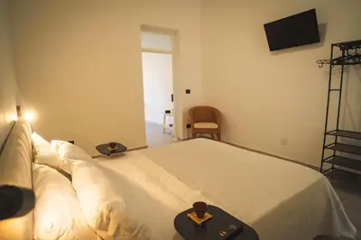 a bedroom with a bed with a cross on it at qanatapartment in Palermo