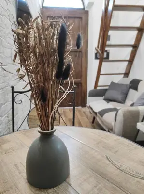 a vase with dried flowers on a table at SottoCapo House in Palermo