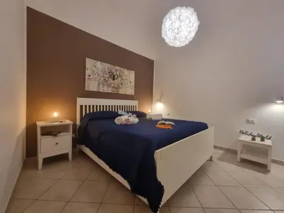 a bedroom with a large bed with a blue blanket at DownTown House by Holiday World in Palermo