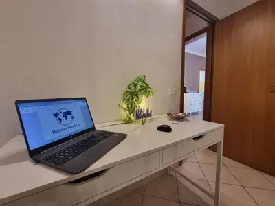 a laptop computer sitting on top of a desk at DownTown House by Holiday World in Palermo