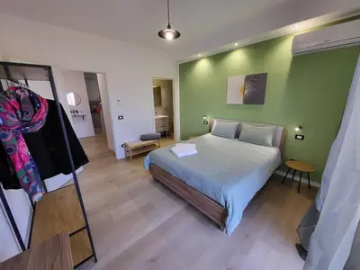 a bedroom with a bed and a green wall at Dante Prime Collection Palermo in Palermo