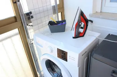 a washer and dryer in a room with a washing machine at Dante Prime Collection Palermo in Palermo