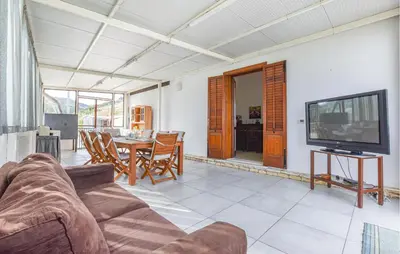 a living room with a couch and a tv and a table at Villa Bruno in Castellammare del Golfo