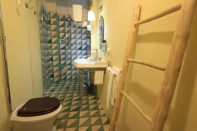 a bathroom with a shower with blue and white tiles at Trinacria Home in Palermo