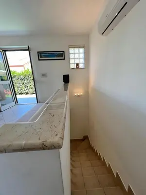 a small room with a counter and a sink at Villa Stromboli - Le Ville del Mediterraneo in Campofelice di Roccella