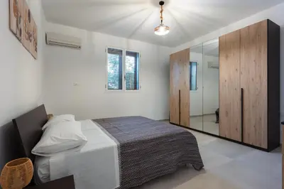 a bedroom with a bed and a large mirror at La Dimora di Icaro - near the sea, the Airport and Palermo in Carini