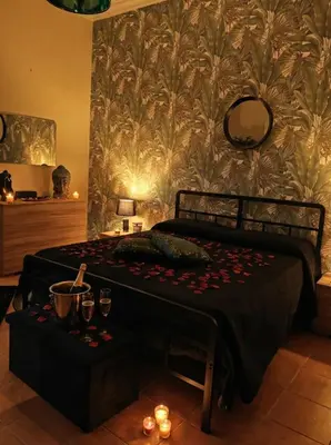 a bedroom with a bed and a table with wine glasses at Guest House Scalia in Palermo